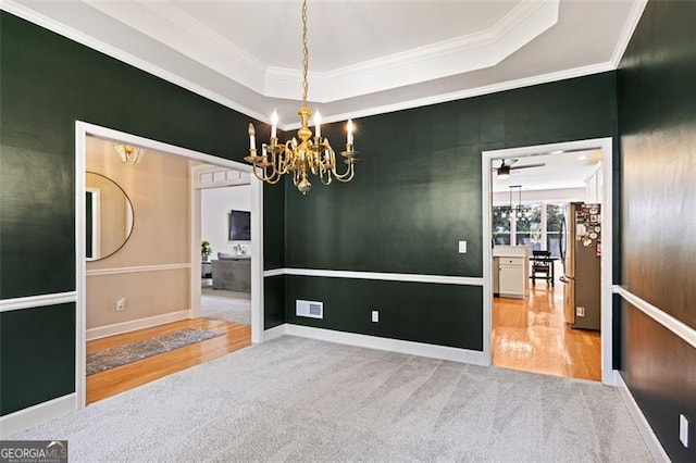 3072 Oaktree, Duluth, GA 30096 - spare room featuring a chandelier, wood finished floors, ornamental molding, a tray ceiling, and carpet flooring