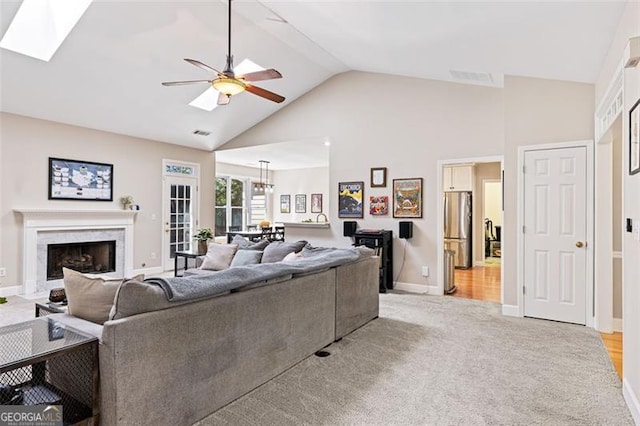 3072 Oaktree, Duluth, GA 30096 - living area with high vaulted ceiling, ceiling fan, light carpet, a high end fireplace, and a skylight