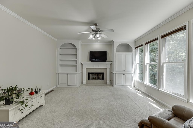 1614 Summersweet Ln, Dacula, GA 30019 - living area with light carpet, a ceiling fan, crown molding, built in shelves, and a fireplace