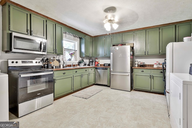 3453 Hogansville Rd, Lagrange, GA 30241 - kitchen featuring green cabinets, stainless steel appliances, washer / dryer, ceiling fan, and a textured ceiling