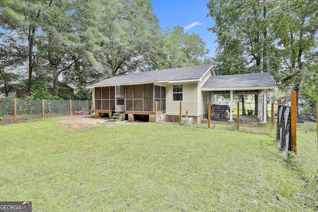 3453 Hogansville Rd, Lagrange, GA 30241 - back of property featuring a sunroom, a fenced backyard, an attached carport, and roof with shingles