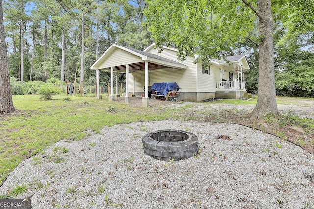 3453 Hogansville Rd, Lagrange, GA 30241 - rear view of property with an outdoor fire pit and a porch