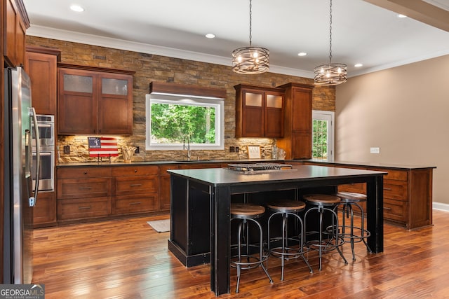 112 Springhill Ln, Clarkesville, GA 30523 - kitchen with dark countertops, freestanding refrigerator, backsplash, a breakfast bar area, and a kitchen island