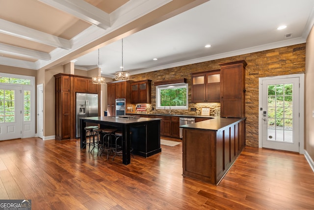 112 Springhill Ln, Clarkesville, GA 30523 - kitchen with appliances with stainless steel finishes, dark countertops, a chandelier, a breakfast bar, and glass insert cabinets