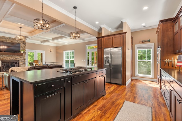 112 Springhill Ln, Clarkesville, GA 30523 - kitchen featuring stainless steel appliances, dark countertops, open floor plan, a kitchen island, and a stone fireplace