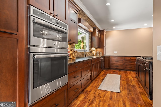 112 Springhill Ln, Clarkesville, GA 30523 - kitchen featuring stainless steel double oven, dark wood-style flooring, tasteful backsplash, recessed lighting, and glass insert cabinets