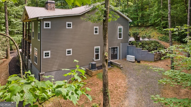 112 Springhill Ln, Clarkesville, GA 30523 - view of side of home with a chimney and a central air condition unit