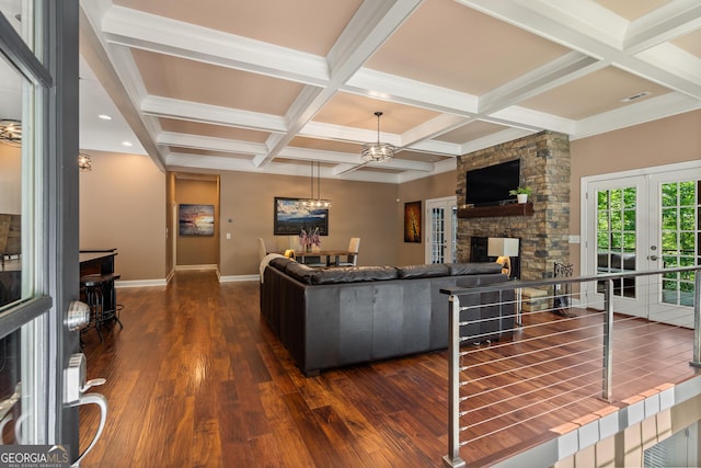 112 Springhill Ln, Clarkesville, GA 30523 - living room featuring dark wood-type flooring, a stone fireplace, a chandelier, coffered ceiling, and beamed ceiling