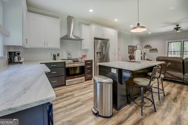 2591 Reids Ferry Rd, Buckhead, GA 30625 - kitchen featuring wall chimney exhaust hood, appliances with stainless steel finishes, ornamental molding, light wood-style floors, and white cabinets