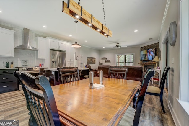 2591 Reids Ferry Rd, Buckhead, GA 30625 - dining space featuring ornamental molding, ceiling fan, light wood-style floors, recessed lighting, and a stone fireplace