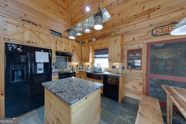335 Jones Rd, Jefferson, GA 30549 - kitchen with black appliances, under cabinet range hood, light brown cabinets, wood walls, and dark stone counters