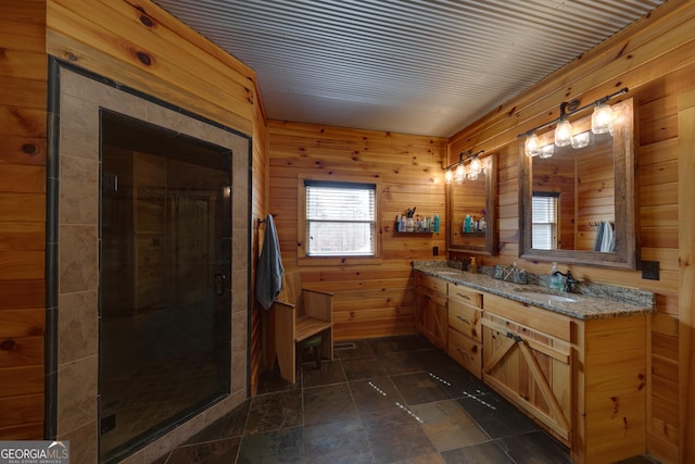 335 Jones Rd, Jefferson, GA 30549 - bathroom with double vanity, wood walls, a stall shower, and stone finish floors
