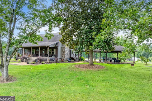 335 Jones Rd, Jefferson, GA 30549 - back of property with a yard, a porch, stone siding, a carport, and roof with shingles