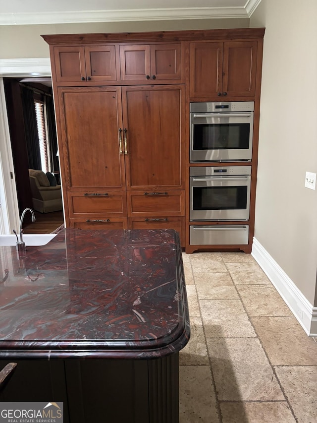 320 E 3rd Ave, Rome, GA 30161 - kitchen featuring a warming drawer, stainless steel double oven, crown molding, and stone tile floors