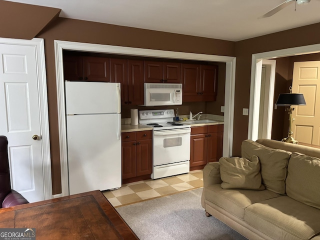 320 E 3rd Ave, Rome, GA 30161 - kitchen with white appliances, light floors, open floor plan, light countertops, and ceiling fan