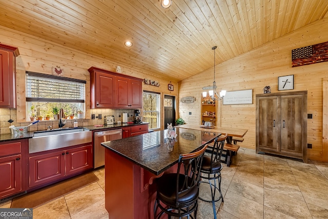 339 Jones Rd, Jefferson, GA 30549 - kitchen featuring stainless steel dishwasher, wooden walls, reddish brown cabinets, vaulted ceiling, and a chandelier