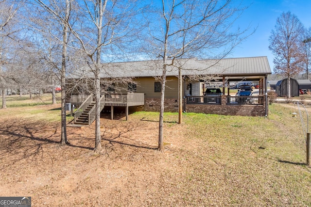 339 Jones Rd, Jefferson, GA 30549 - back of house featuring a deck, a metal roof, and a yard