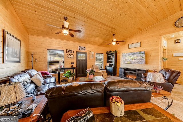 339 Jones Rd, Jefferson, GA 30549 - living room featuring a ceiling fan, lofted ceiling, wooden walls, a glass covered fireplace, and wooden ceiling