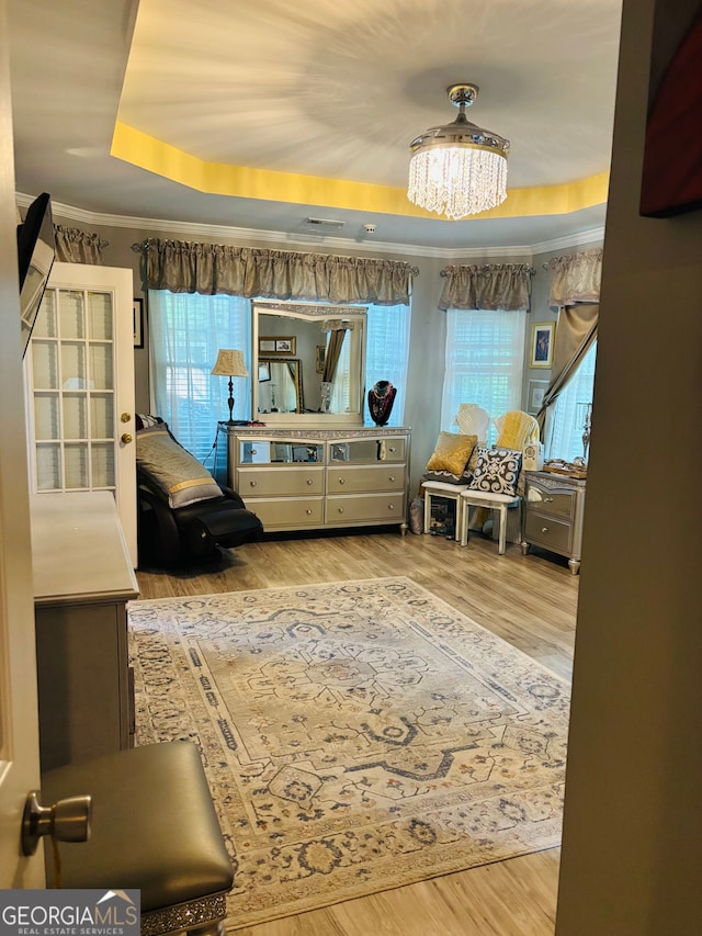3545 SW Renaissance Cir, Atlanta, GA 30349 - interior space with a raised ceiling, wood finished floors, a chandelier, and ornamental molding