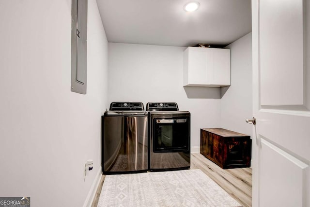 2200 Glendale Dr, Atlanta, GA 30032 - washroom featuring cabinet space, washing machine and dryer, light wood-style flooring, and electric panel