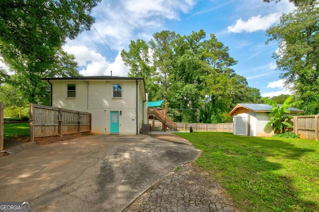 2200 Glendale Dr, Atlanta, GA 30032 - rear view of property with a storage unit, a fenced backyard, and stairway