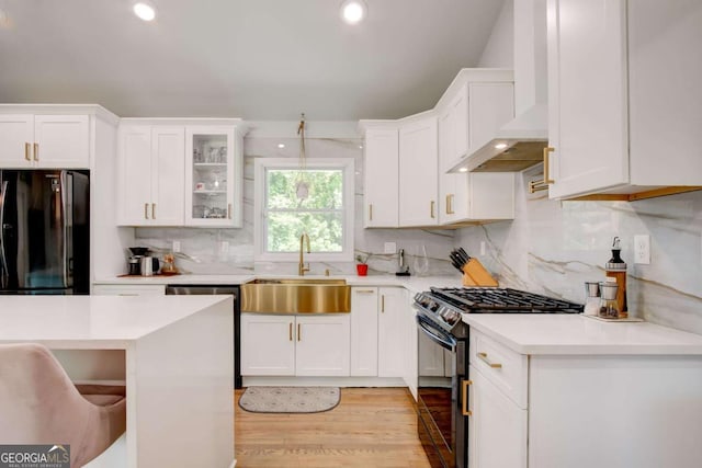 2200 Glendale Dr, Atlanta, GA 30032 - kitchen with black appliances, wall chimney range hood, light countertops, white cabinets, and recessed lighting