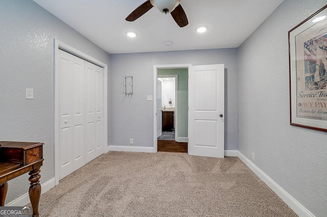 281 Noel C Conaway Rd, Guyton, GA 31312 - unfurnished bedroom featuring carpet flooring, a closet, ceiling fan, and a textured wall