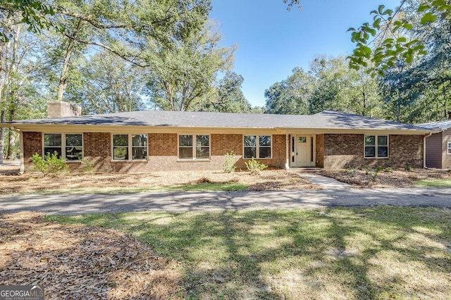 281 Noel C Conaway Rd, Guyton, GA 31312 - single story home with a chimney, brick siding, and a front yard