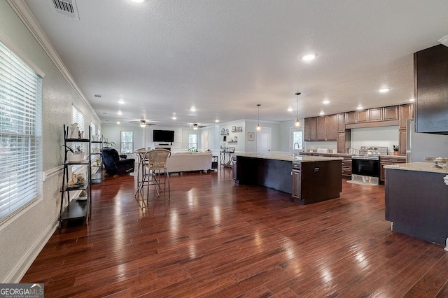 281 Noel C Conaway Rd, Guyton, GA 31312 - kitchen featuring appliances with stainless steel finishes, open floor plan, ceiling fan, a kitchen island with sink, and dark wood-type flooring