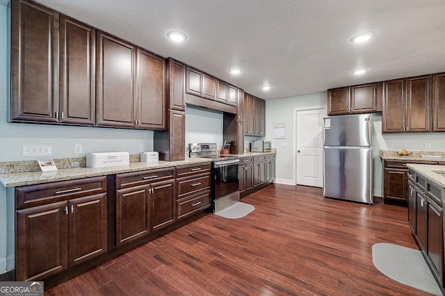 281 Noel C Conaway Rd, Guyton, GA 31312 - kitchen featuring appliances with stainless steel finishes, dark wood finished floors, dark brown cabinets, recessed lighting, and a textured ceiling