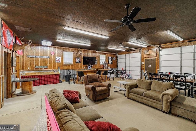 2452 Malcom Bridge Rd, Bogart, GA 30622 - garage featuring a ceiling fan and wood walls