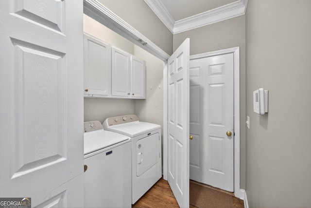 103 W Second St, Greensboro, GA 30642 - washroom featuring ornamental molding, cabinet space, separate washer and dryer, and wood finished floors