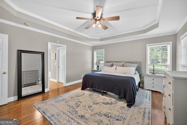 103 W Second St, Greensboro, GA 30642 - bedroom featuring a raised ceiling, wood finished floors, ornamental molding, and a ceiling fan