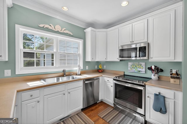 103 W Second St, Greensboro, GA 30642 - kitchen with stainless steel appliances, white cabinets, light countertops, dark wood-type flooring, and recessed lighting