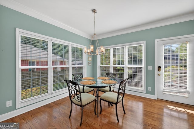 103 W Second St, Greensboro, GA 30642 - dining space featuring crown molding, a chandelier, and wood finished floors