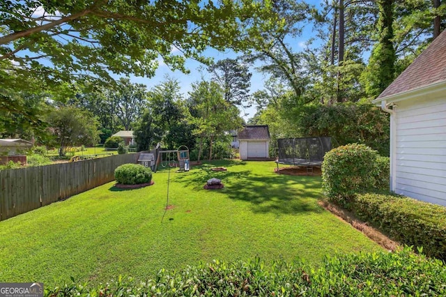 103 W Second St, Greensboro, GA 30642 - fenced backyard with a trampoline and a storage unit