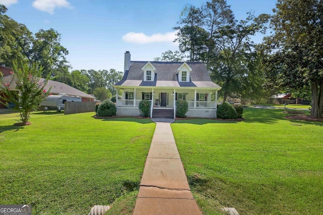 103 W Second St, Greensboro, GA 30642 - new england style home featuring a porch, a chimney, and a front lawn
