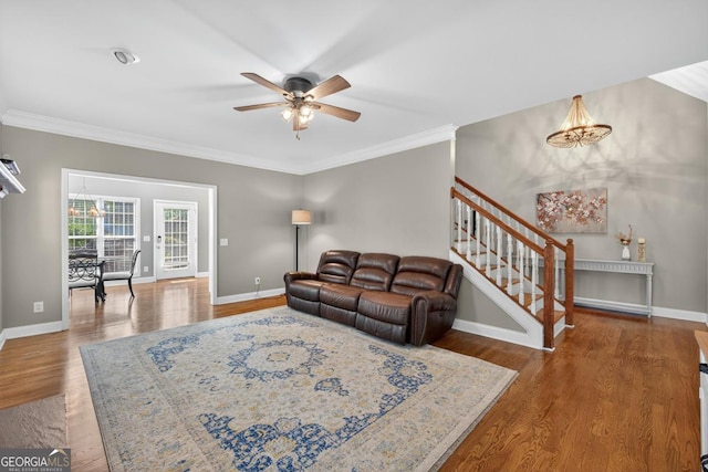 103 W Second St, Greensboro, GA 30642 - living room featuring stairway, ceiling fan, wood finished floors, ornamental molding, and a chandelier