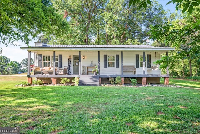 1724 Cedar Grove Church Rd, Winder, GA 30680 - view of front of home featuring covered porch, a front lawn, and a metal roof