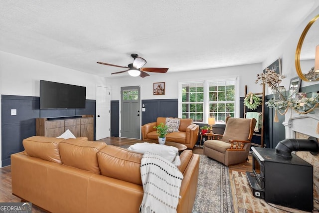1724 Cedar Grove Church Rd, Winder, GA 30680 - living area with wood finished floors, a wood stove, and a ceiling fan