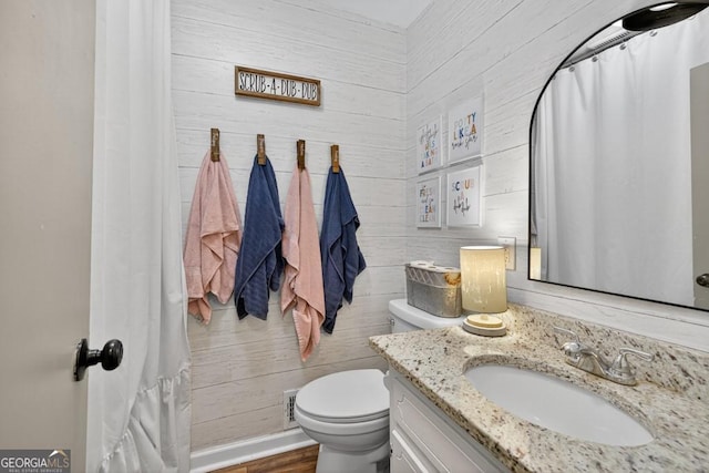 1724 Cedar Grove Church Rd, Winder, GA 30680 - bathroom with vanity, wooden walls, curtained shower, and wood finished floors
