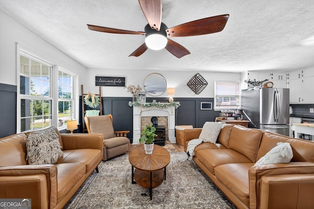 1724 Cedar Grove Church Rd, Winder, GA 30680 - living area featuring a textured ceiling, a ceiling fan, and wainscoting