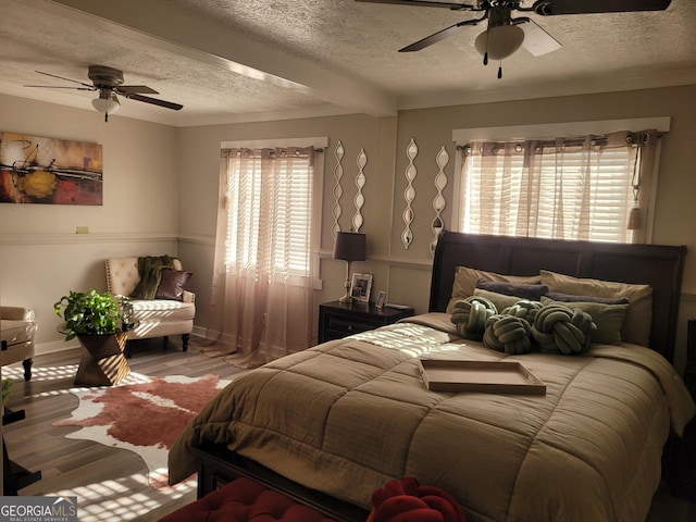 1625 Conley Rd Unit 229, Conley, GA 30288 - bedroom featuring a textured ceiling, multiple windows, light wood finished floors, and a ceiling fan