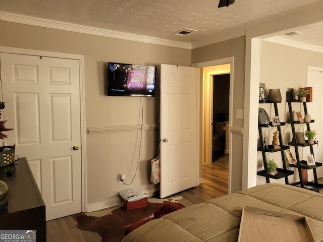 1625 Conley Rd Unit 229, Conley, GA 30288 - bedroom with wood finished floors, crown molding, and a textured ceiling