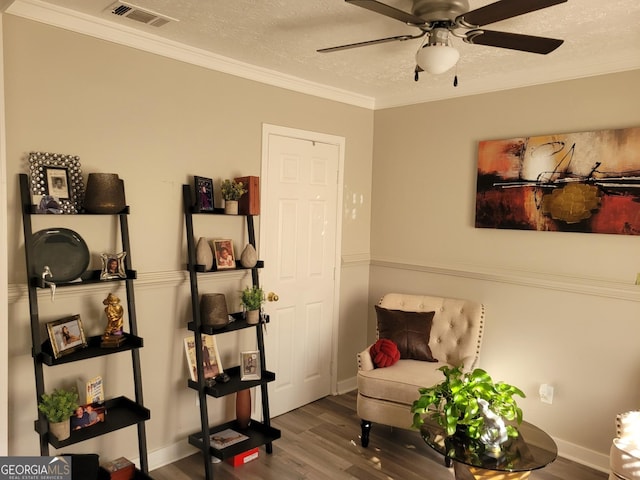 1625 Conley Rd Unit 229, Conley, GA 30288 - living area featuring wood finished floors, a textured ceiling, a ceiling fan, and crown molding