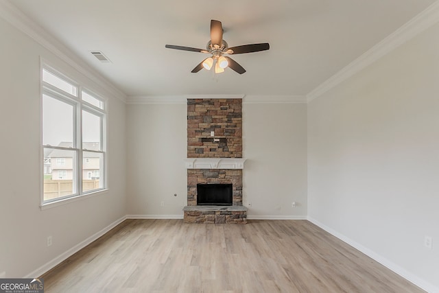 70 Trinity Ln, Covington, GA 30016 - unfurnished living room with healthy amount of natural light, ceiling fan, light wood-style flooring, ornamental molding, and a fireplace