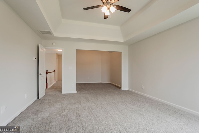70 Trinity Ln, Covington, GA 30016 - unfurnished bedroom featuring carpet flooring, a raised ceiling, a closet, and a ceiling fan