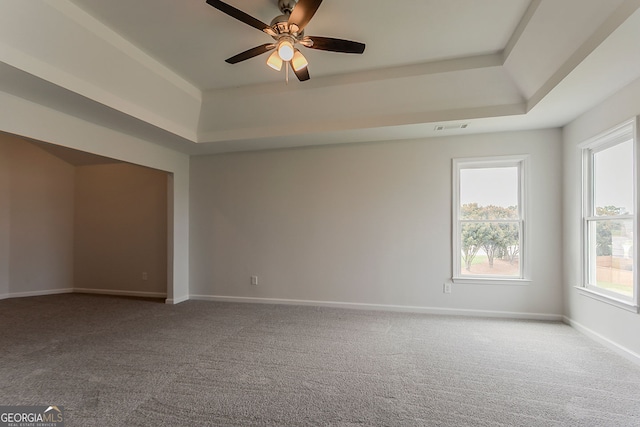 70 Trinity Ln, Covington, GA 30016 - carpeted empty room with a raised ceiling and ceiling fan