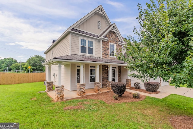 70 Trinity Ln, Covington, GA 30016 - craftsman inspired home with a standing seam roof, stone siding, board and batten siding, and covered porch