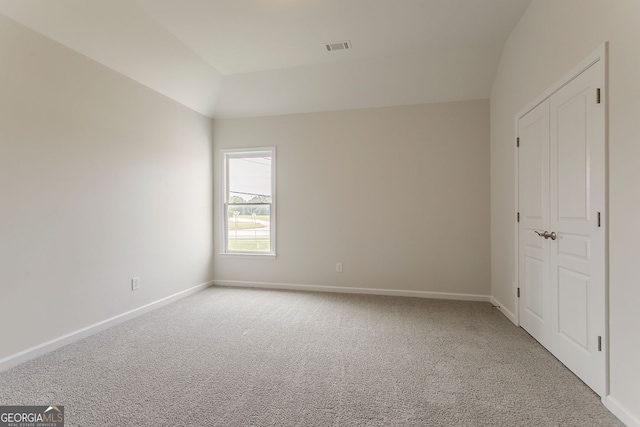 70 Trinity Ln, Covington, GA 30016 - unfurnished bedroom featuring carpet and vaulted ceiling